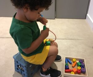 Child threading activity motor skill